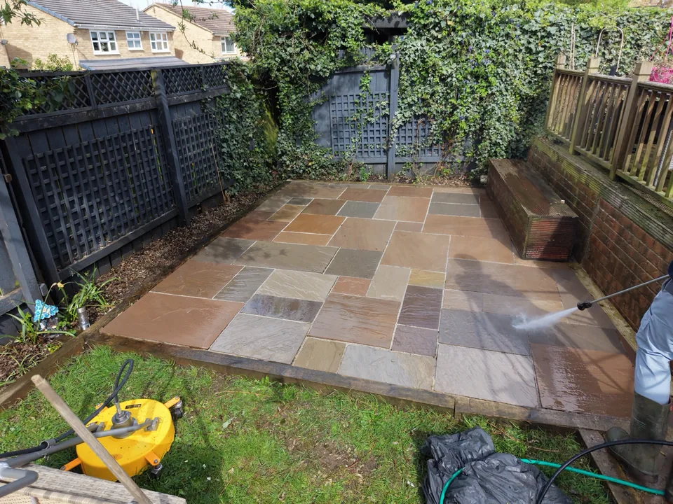 Domestic patio being pressure washed with a surface cleaner