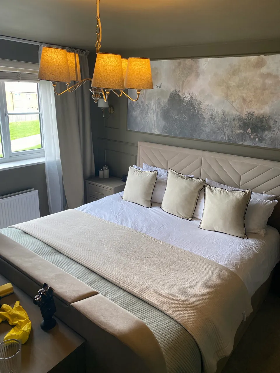 Guest-ready serviced accommodation bedroom with fresh white bedding and styled cushions